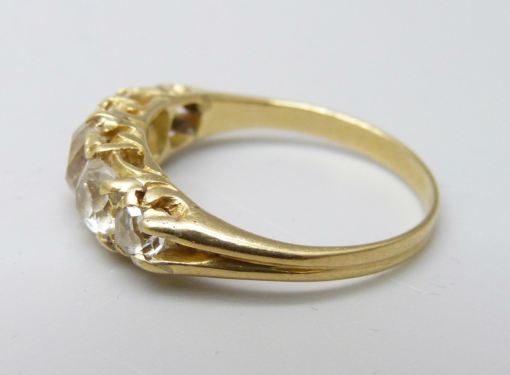 A yellow metal ring, (tests as 18ct gold), set with five old-cut diamonds on a double strand D- - Image 2 of 3