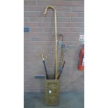 A brass covered stick stand with seven walking sticks and a crook **PLEASE NOTE THIS LOT IS NOT