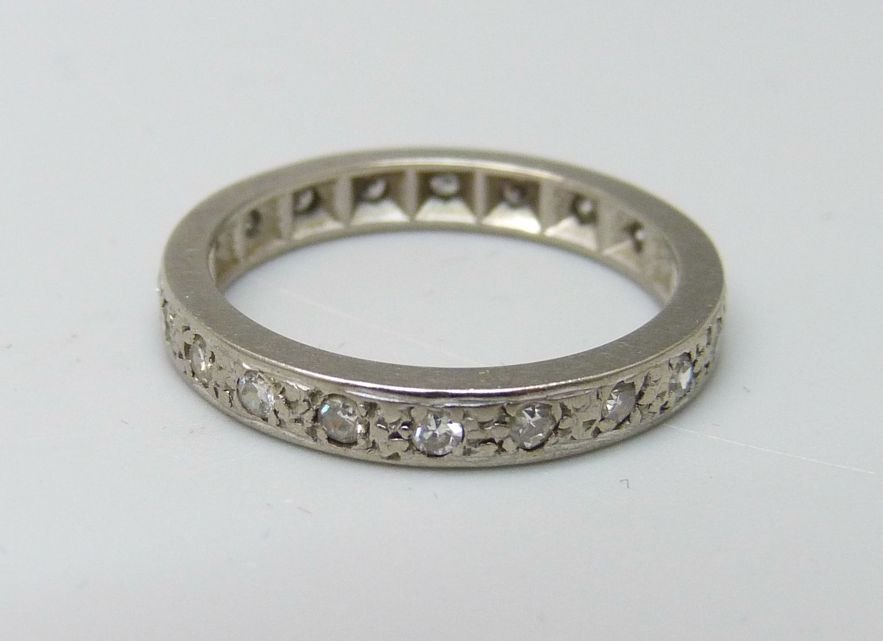 A white metal and diamond eternity ring, 3.4g, L