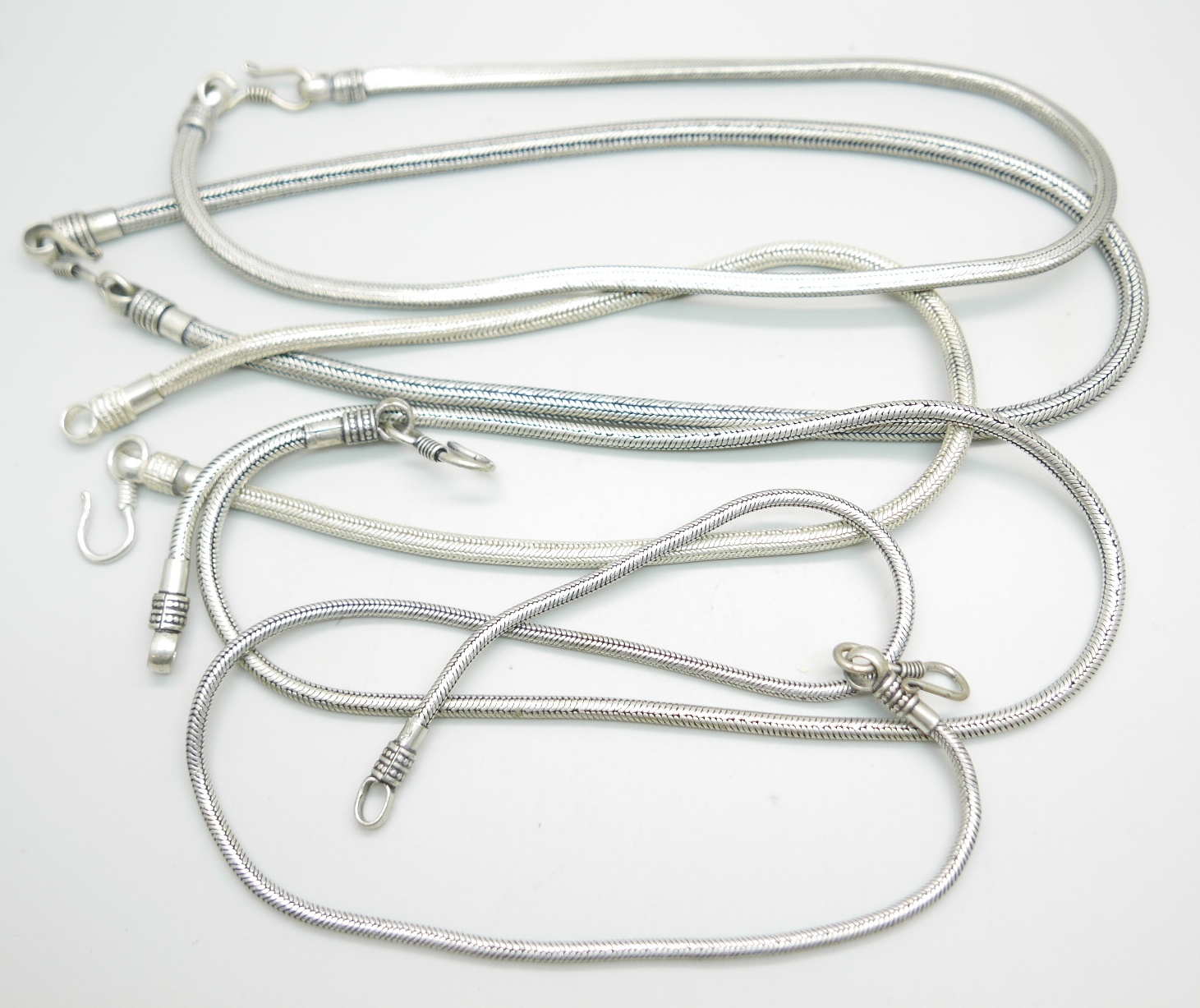 Five white metal neck chains