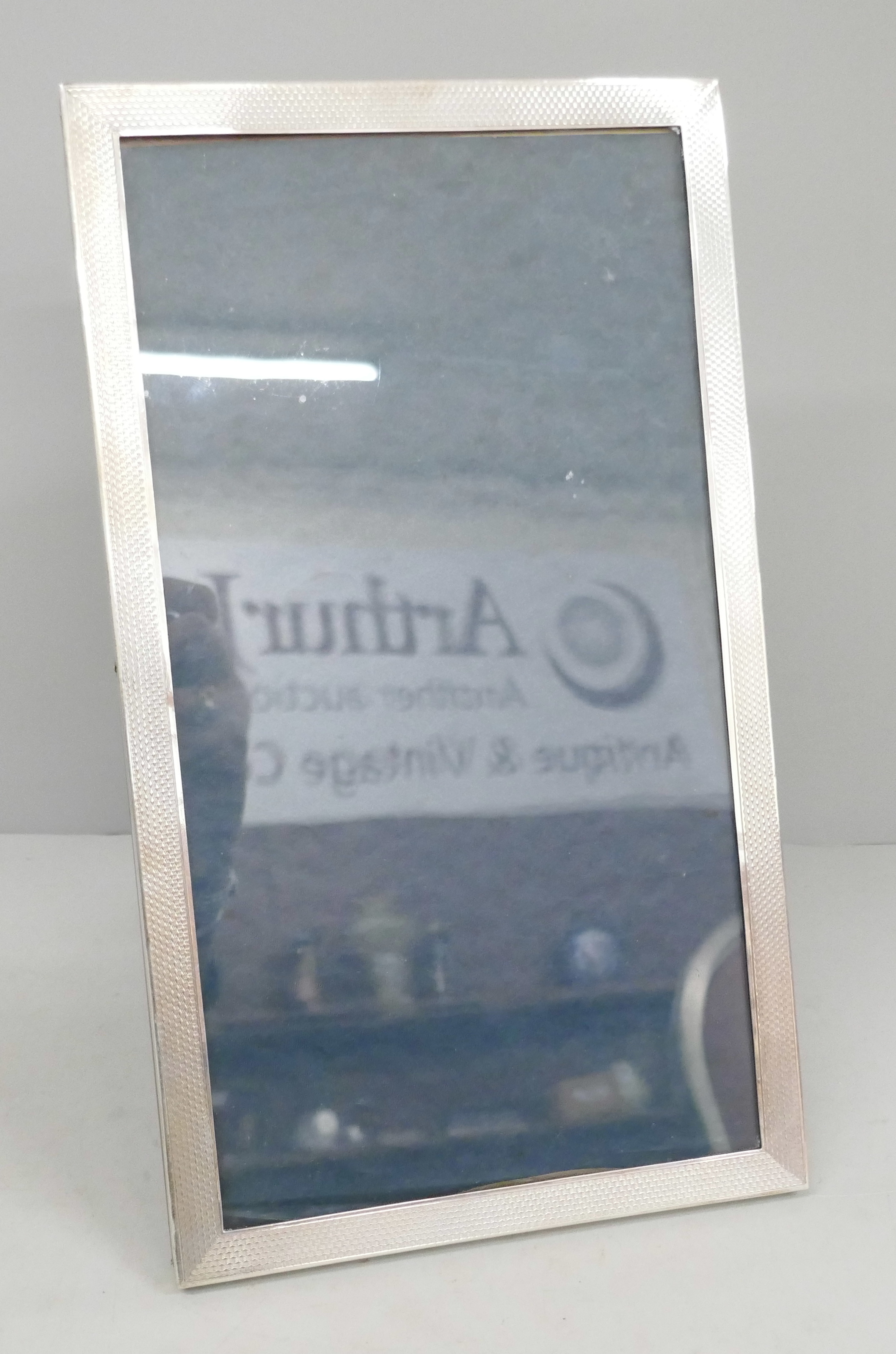 A silver photograph frame, 17cm wide