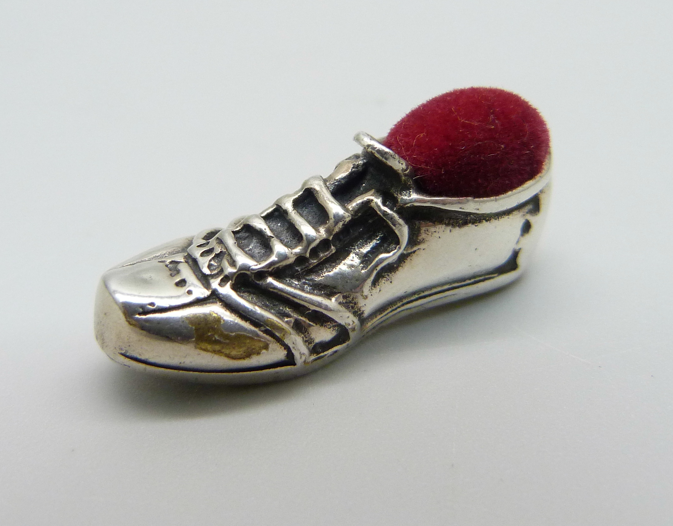 A silver small novelty pin cushion in the form of a football boot, 27mm