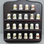 A Franklin Mint set of thimbles, Songbirds of the World, 22 thimbles on a wooden stand