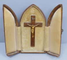 A travelling crucifix shrine in a faux leather tri-fold case