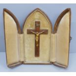 A travelling crucifix shrine in a faux leather tri-fold case