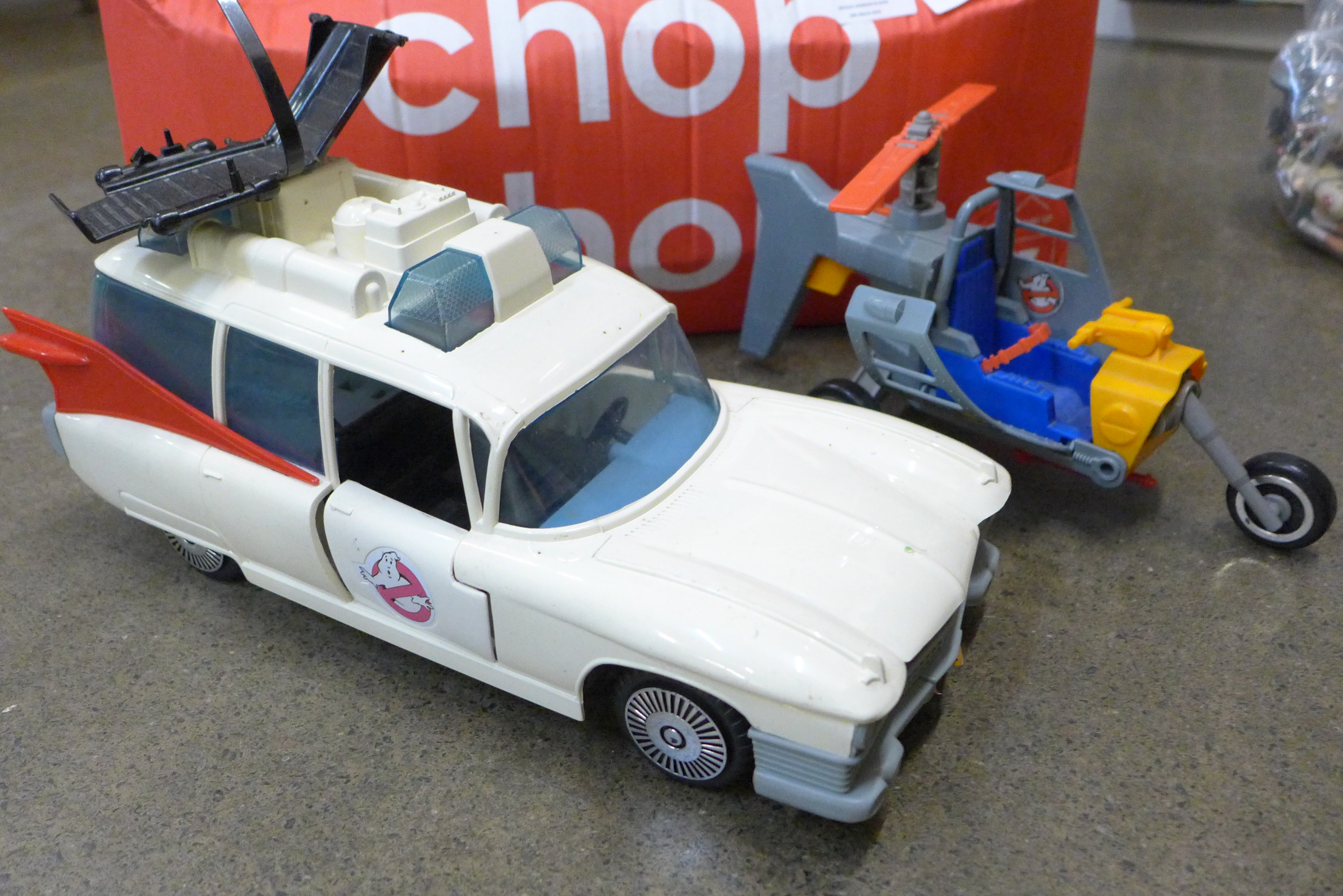 A box of Ghostbusters figures and a model vehicle