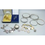 Silver jewellery including four silver bangles and a silver charm bracelet, coins and a sovereign