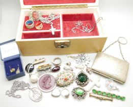 A jewellery box and contents including a silver locket, three chains and ring, and a plated purse