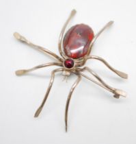 A large plated silver spider brooch, set with agate, faceted garnet and pearl eyes