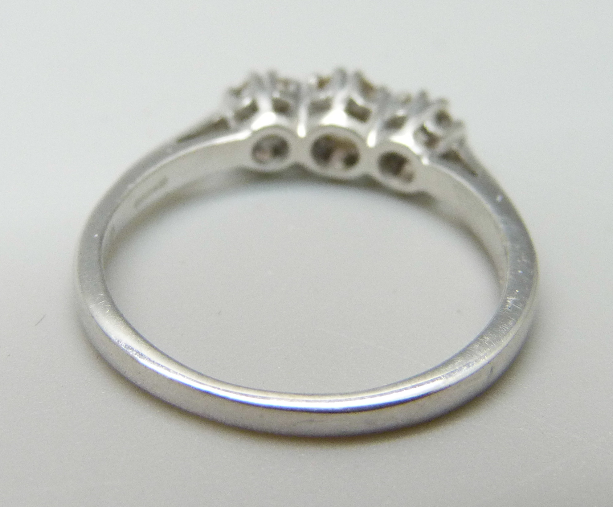 An 18ct white gold and diamond trilogy ring, 0.5ct total diamond weight marked on the shank, 3.2g, O - Image 3 of 3