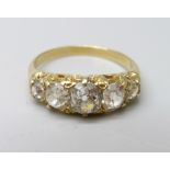 A yellow metal ring, (tests as 18ct gold), set with five old-cut diamonds on a double strand D-