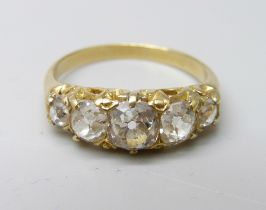 A yellow metal ring, (tests as 18ct gold), set with five old-cut diamonds on a double strand D-