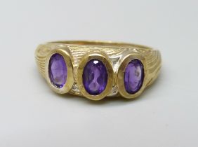 A silver gilt and amethyst trilogy ring, P