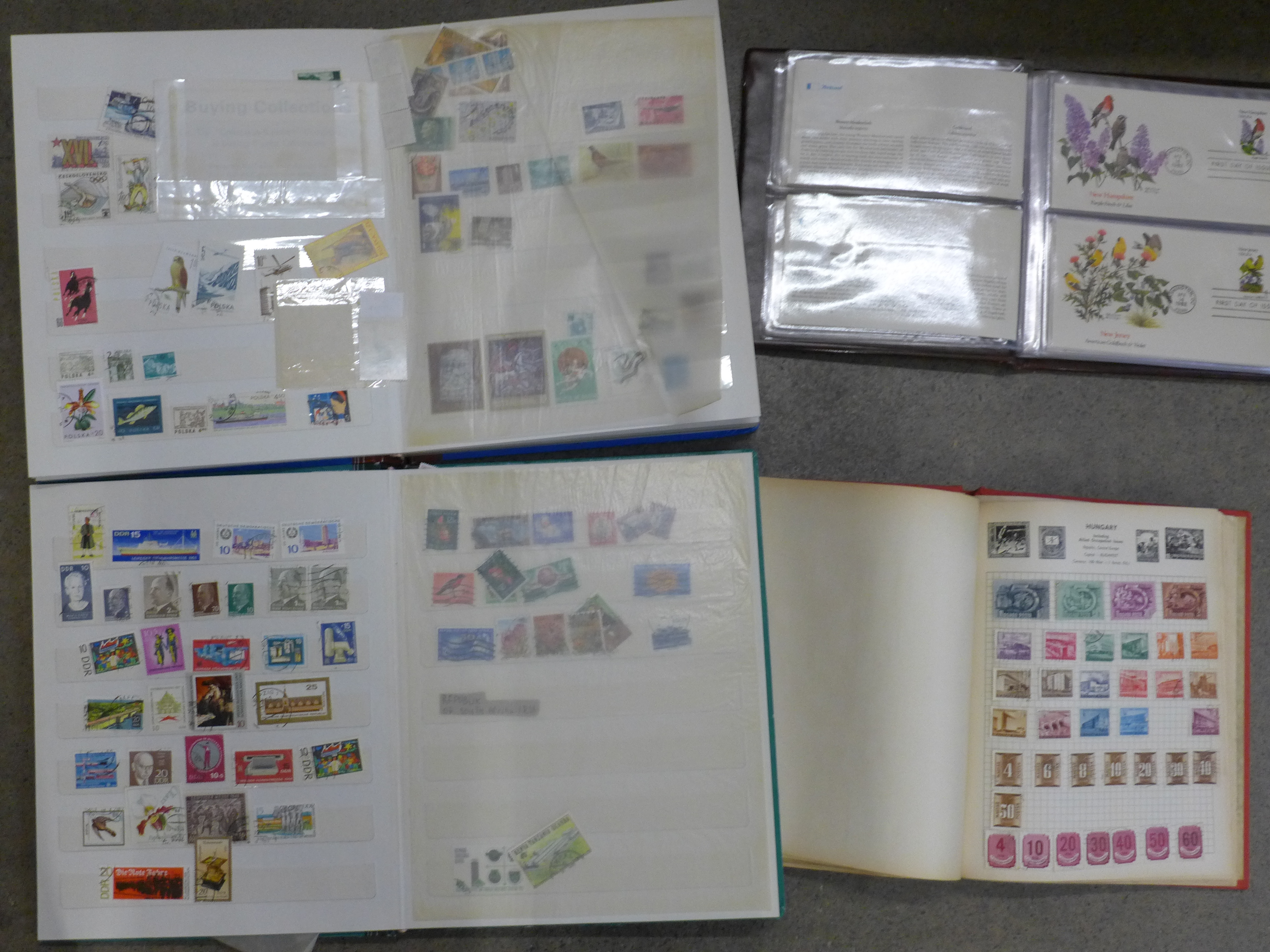 A collection of stamp albums and first day covers including 'Birds & Flowers of the 50 States',