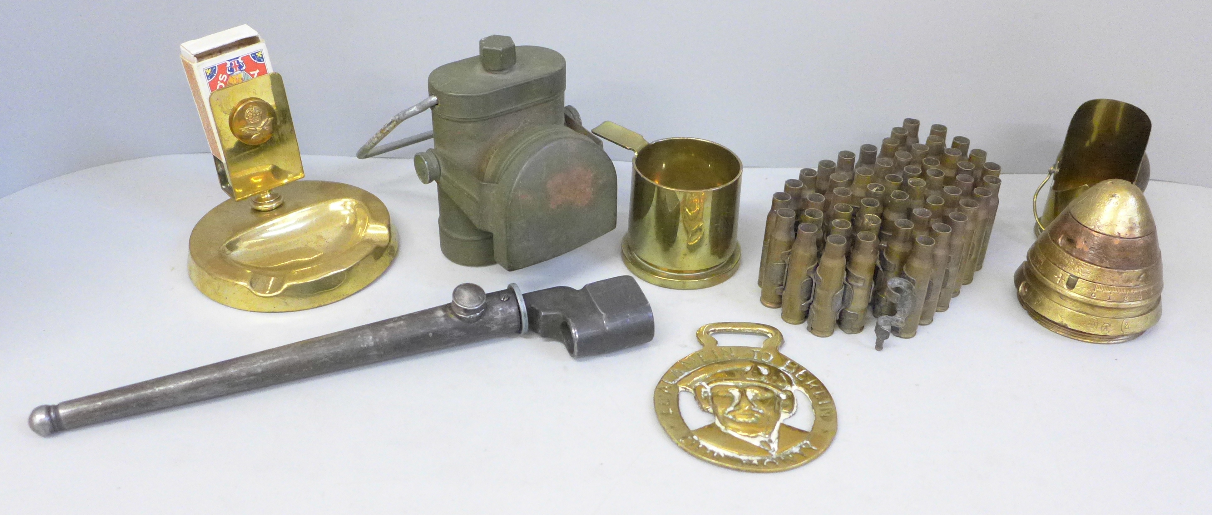 Military related items including a brass matchbox holder/ash tray with insignia, spike bayonet,