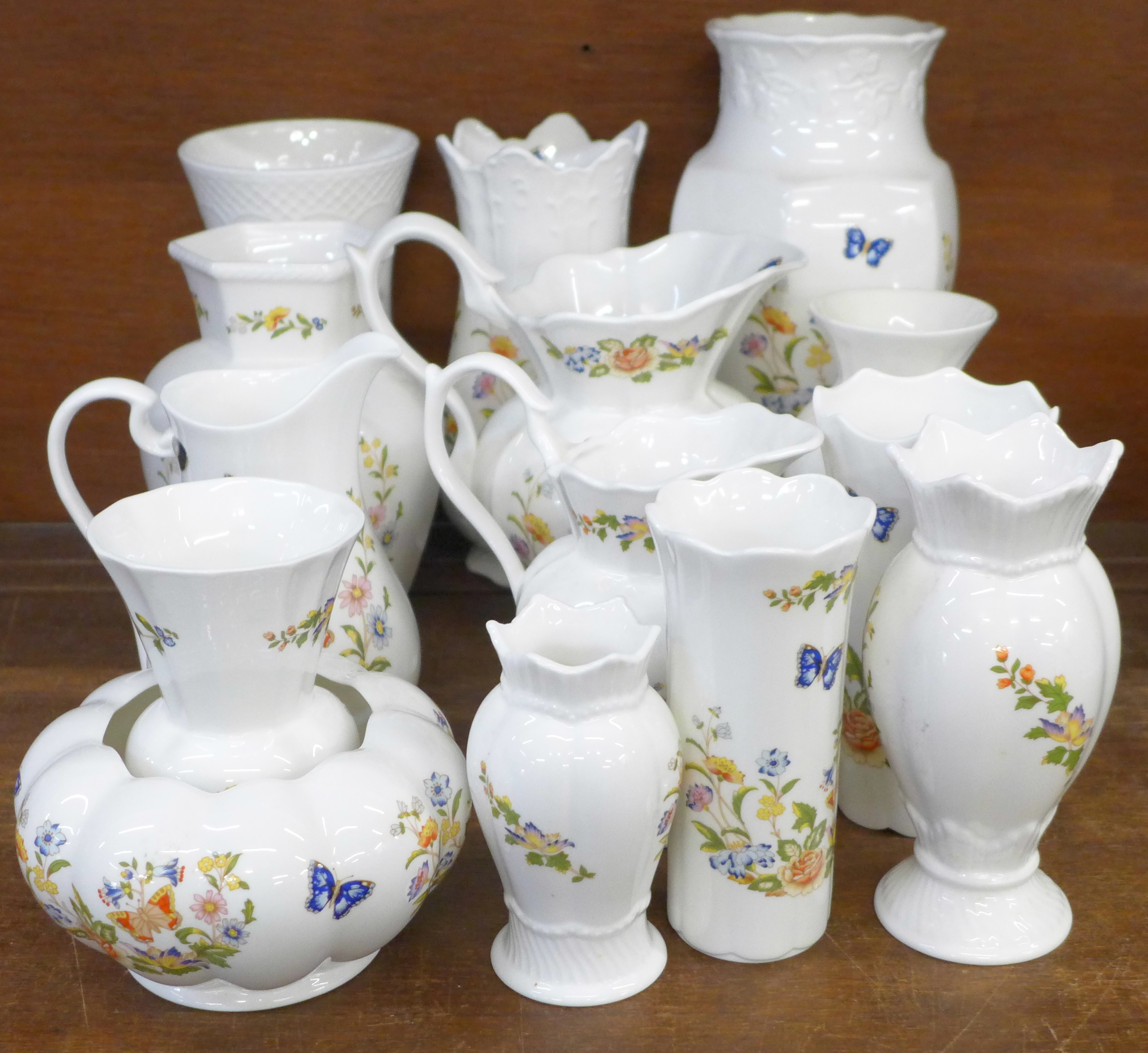 A collection of fourteen Aynsley Cottage Garden vases and jugs