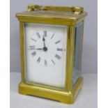 A French brass and four glass sided carriage clock with key