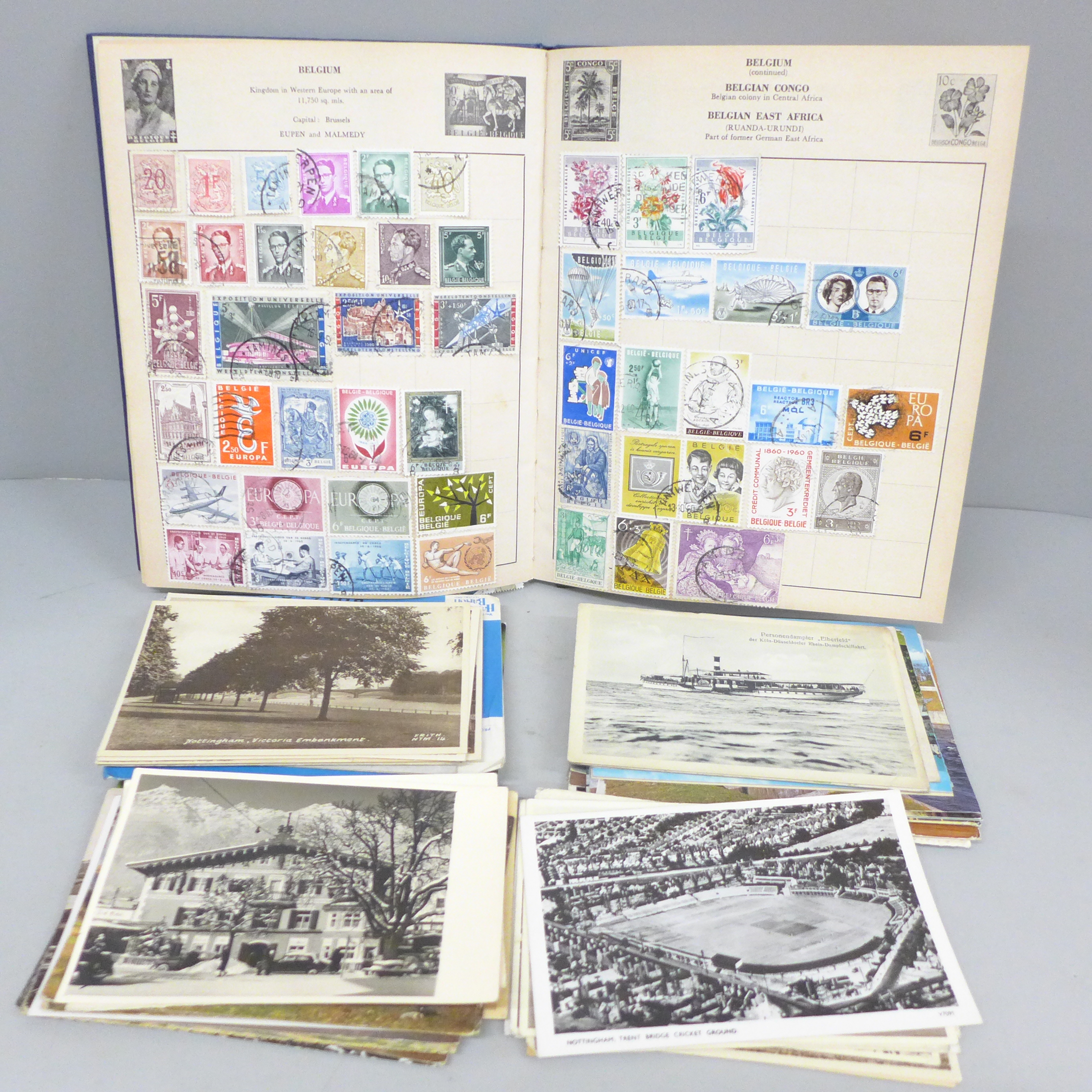 A stamp album and a collection of postcards