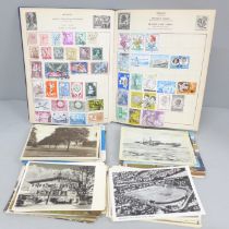 A stamp album and a collection of postcards