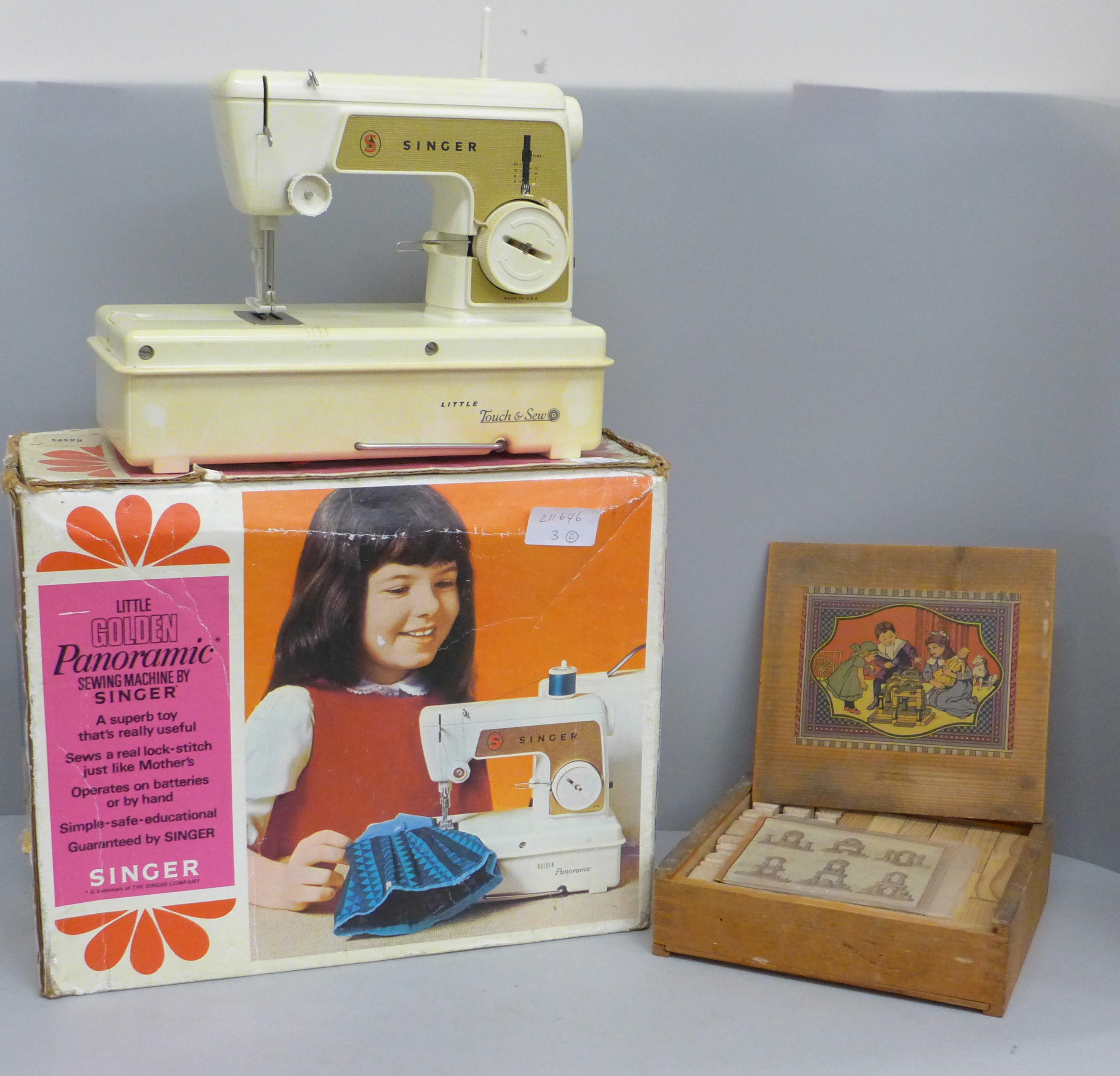 A Little Golden Panoramic sewing machine by Singer and a block building set