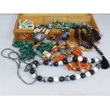 A collection of necklaces, labradorite, coral, Scottish pebble, malachite, in wooden box decorated