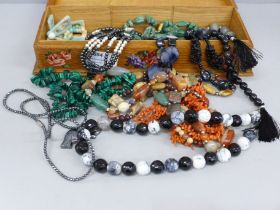 A collection of necklaces, labradorite, coral, Scottish pebble, malachite, in wooden box decorated