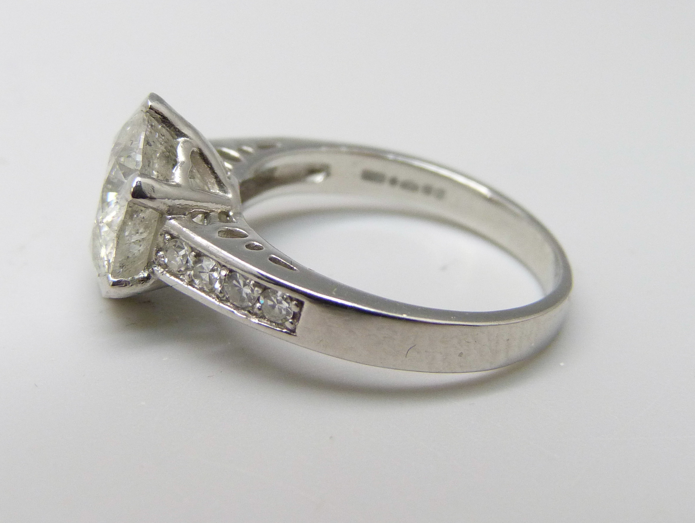 A hallmarked platinum solitaire diamond ring with diamond set shoulders, 3.80cts, 6.2g, M - Image 2 of 4