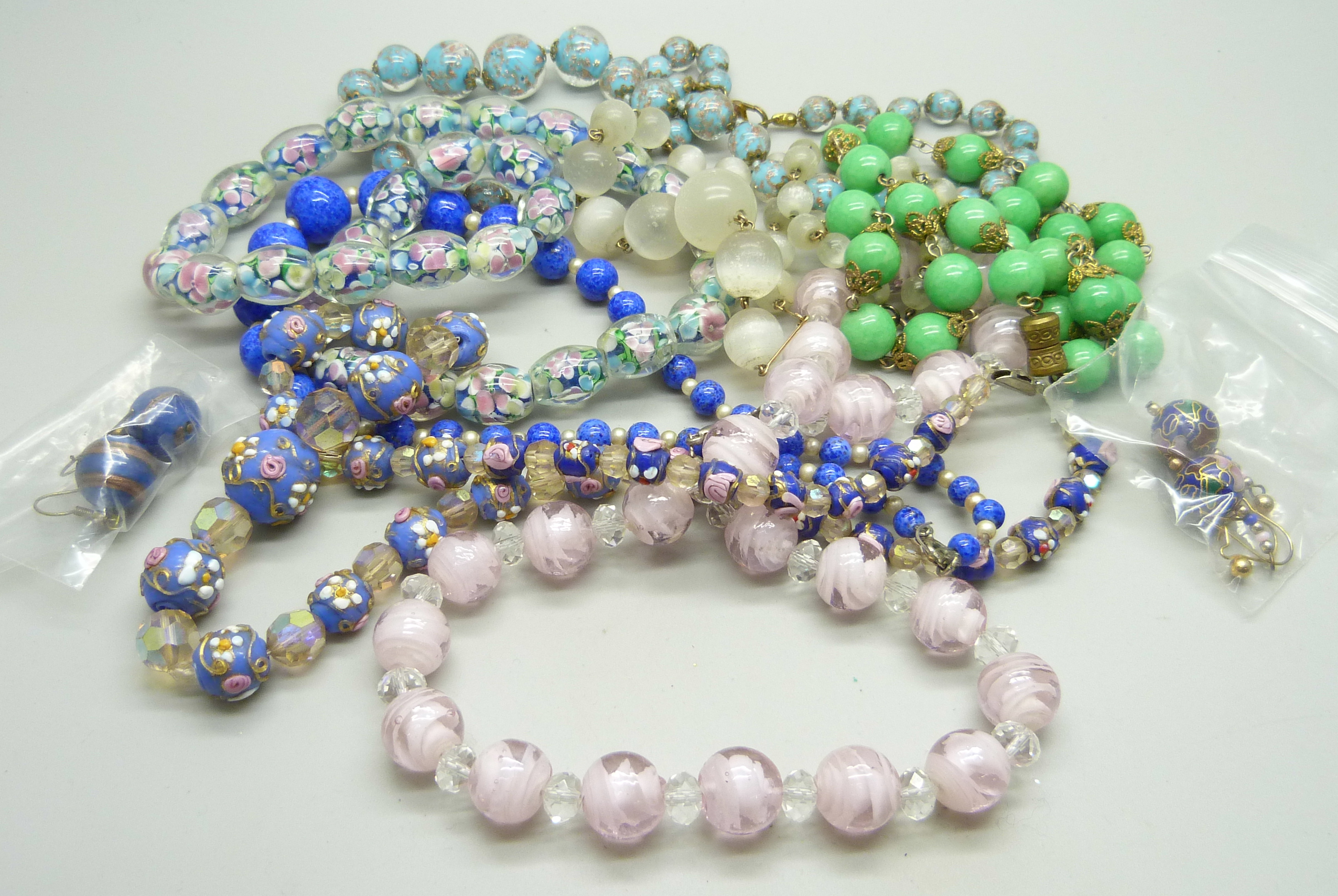 A collection of vintage glass bead necklaces and two pairs of earrings