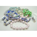 A collection of vintage glass bead necklaces and two pairs of earrings