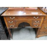 A George III inlaid mahogany five drawer writing table
