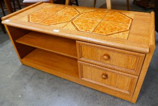 A Schreiber teak and tiled top coffee table