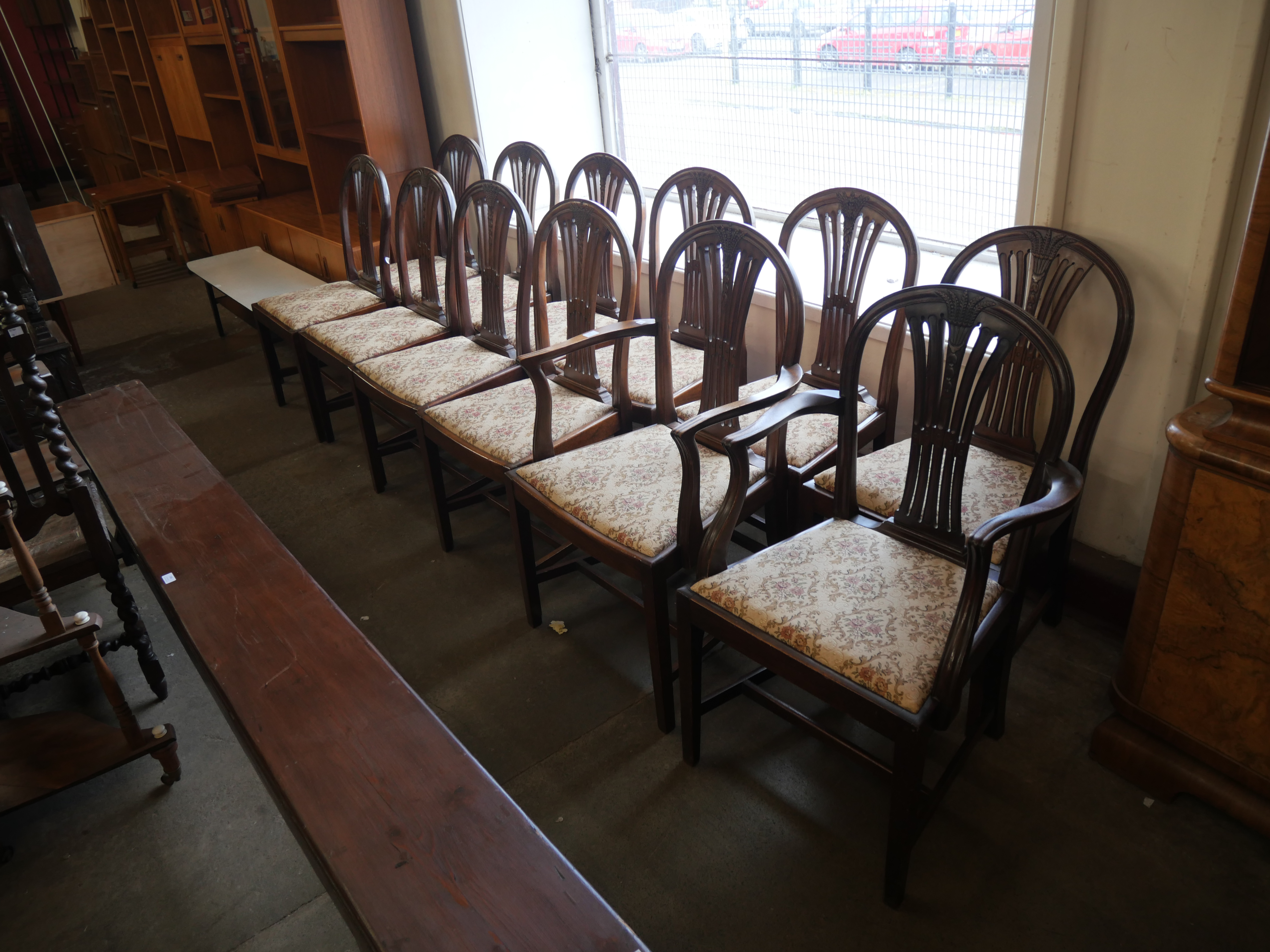 A Harlequin set of twelve Hepplewhite style mahogany dining chairs