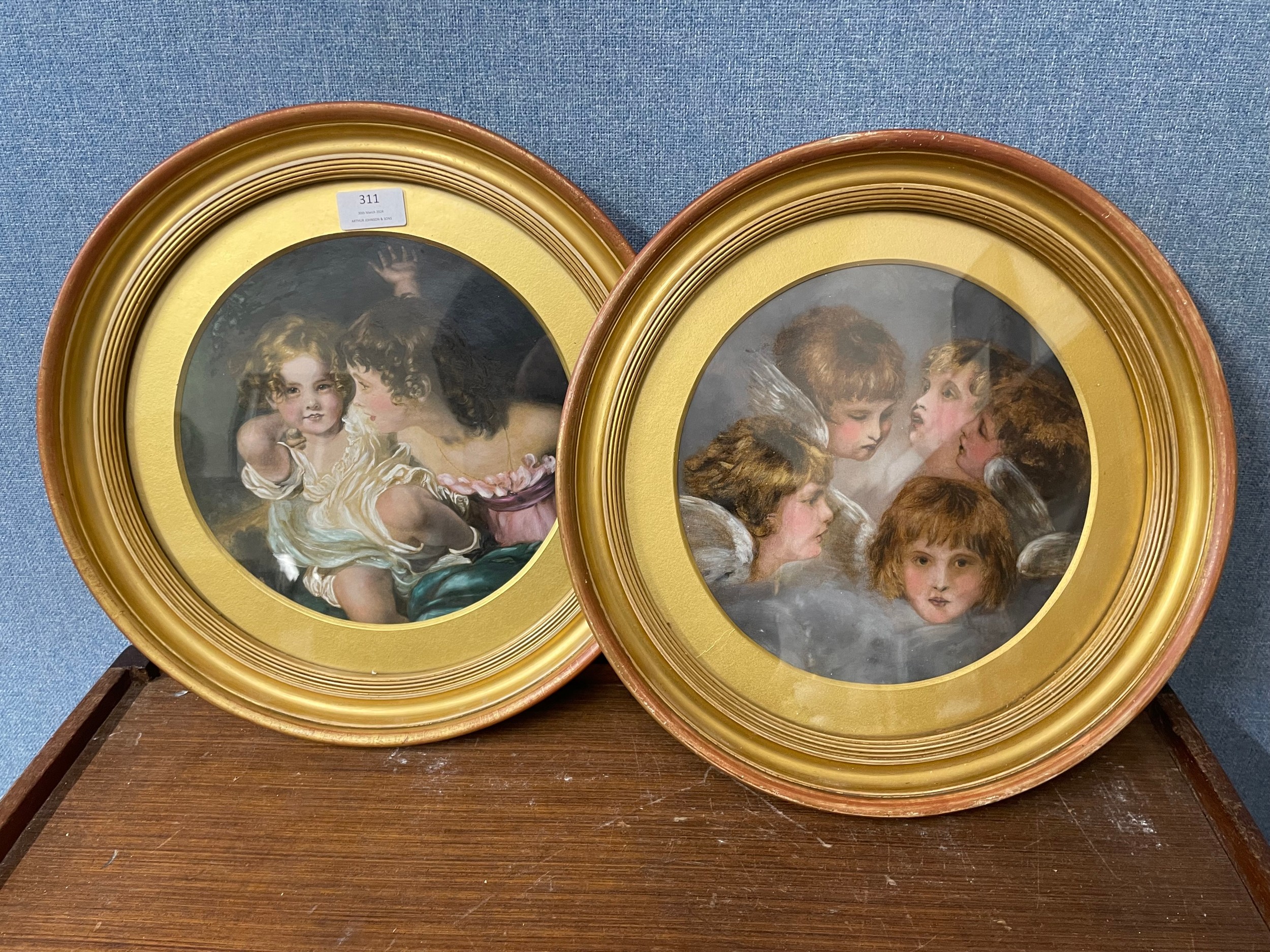 A pair of early 20th Century circular prints of children, framed