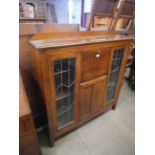 An early 20th Century oak side by side bookcase