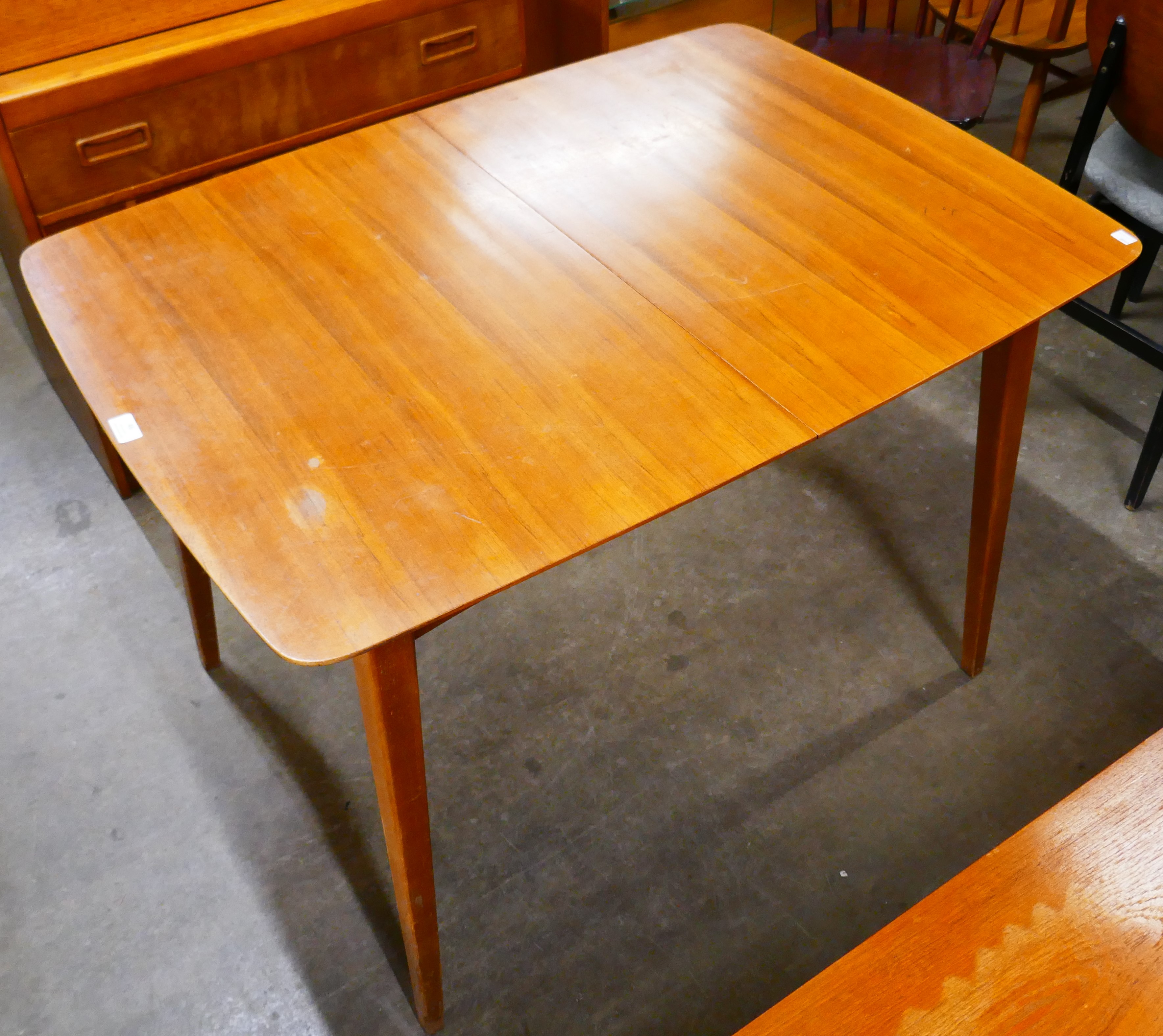 A teak extending dining table