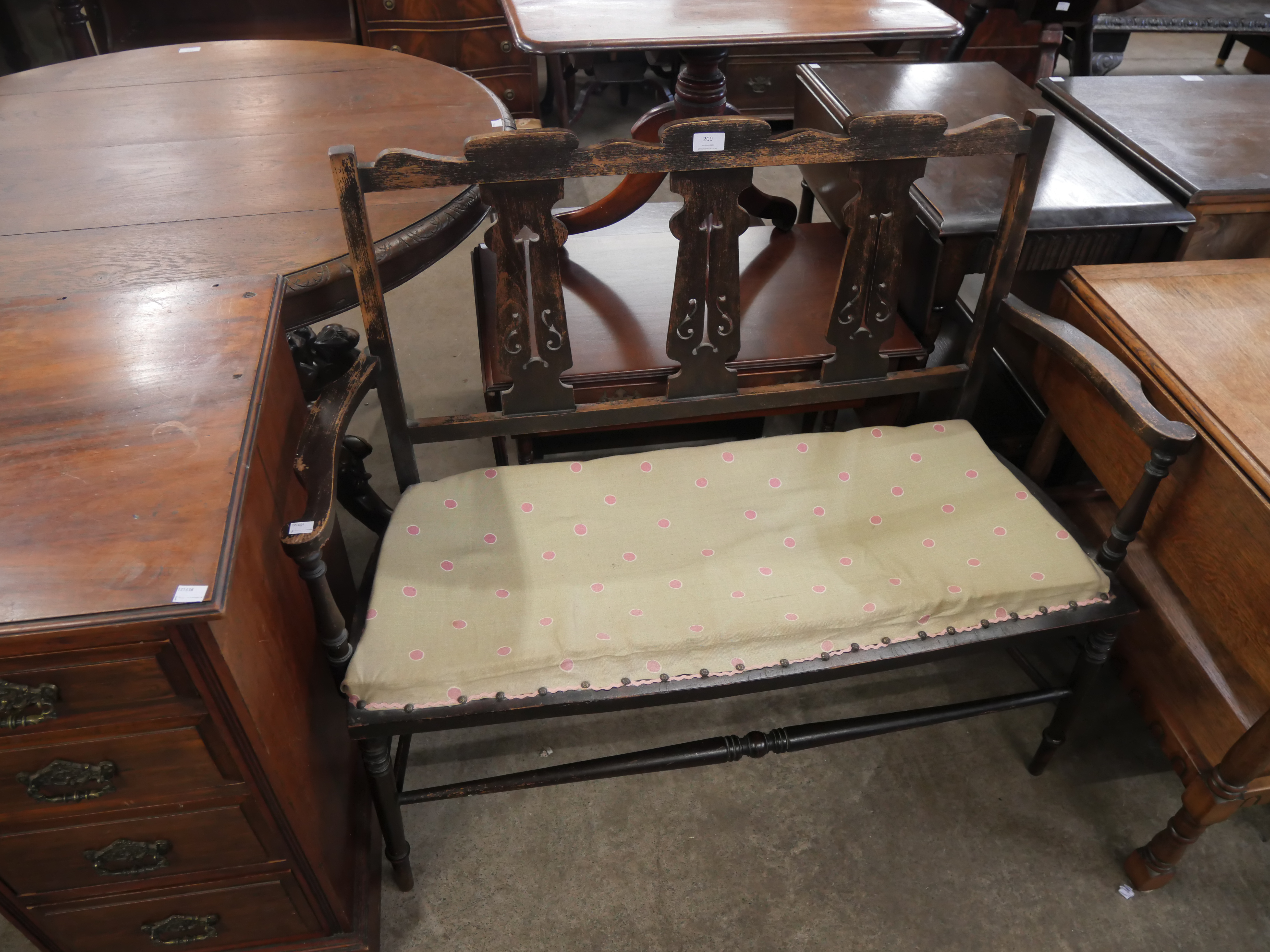 An Arts and Crafts carved oak hall bench