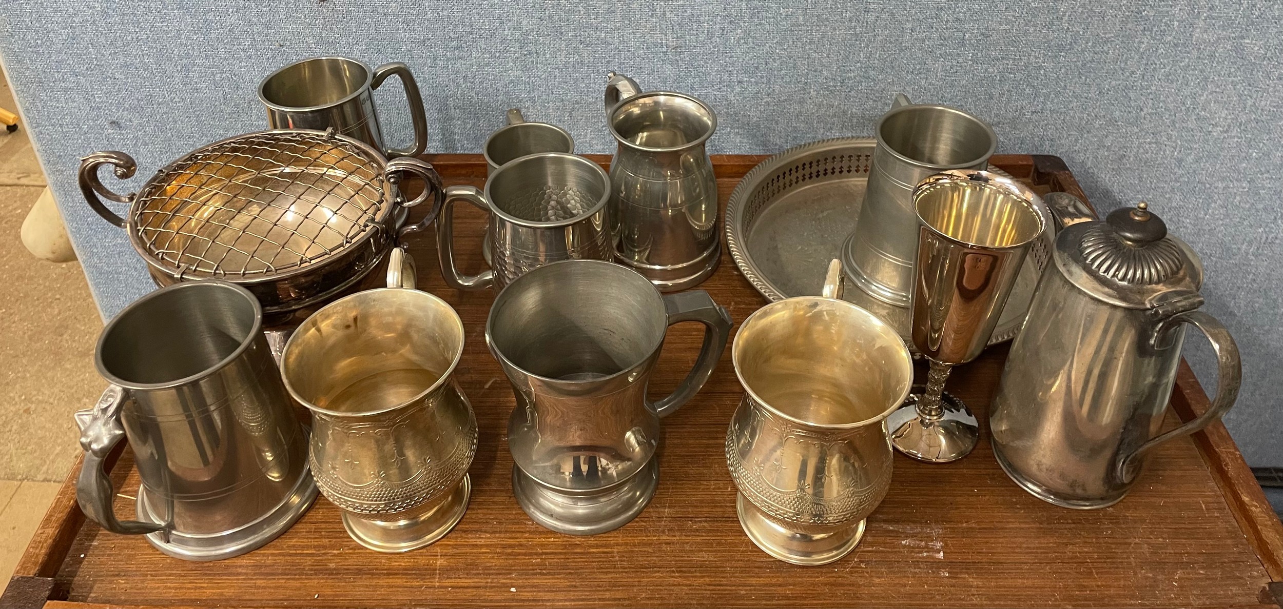 A collection of tankards and plated ware