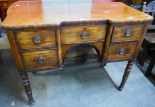 A George IV mahogany inverted breakfront sideboard