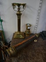 A brass fire hose nozzle, one other nozzle and a brass candlestick