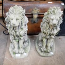 A pair of concrete garden figures of lions