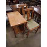 An oak drop leaf table and two oak dining chairs
