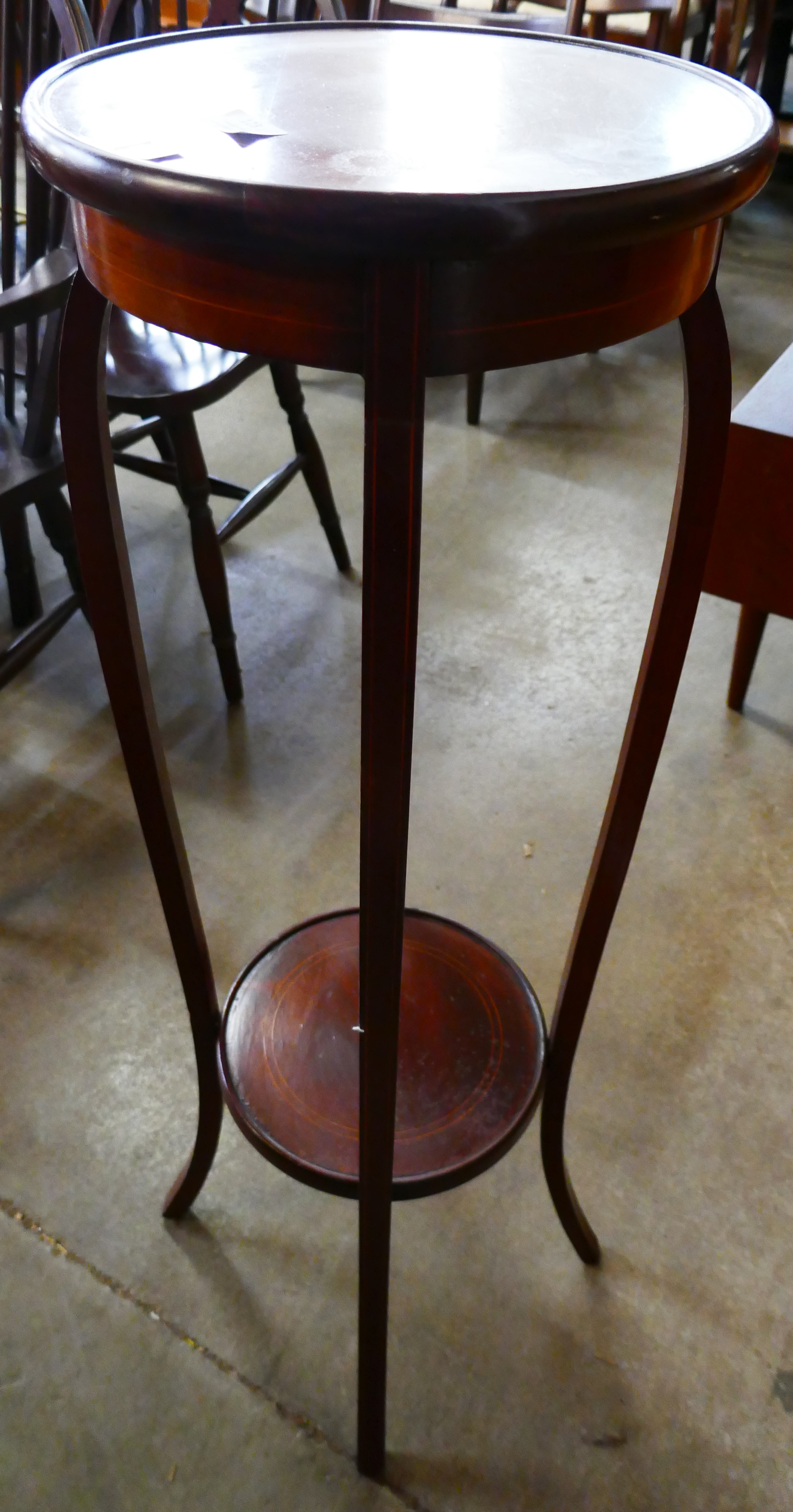 An Edwardian mahogany inlaid plant stand