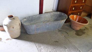 A galvanised tin bath and two large terracotta pots