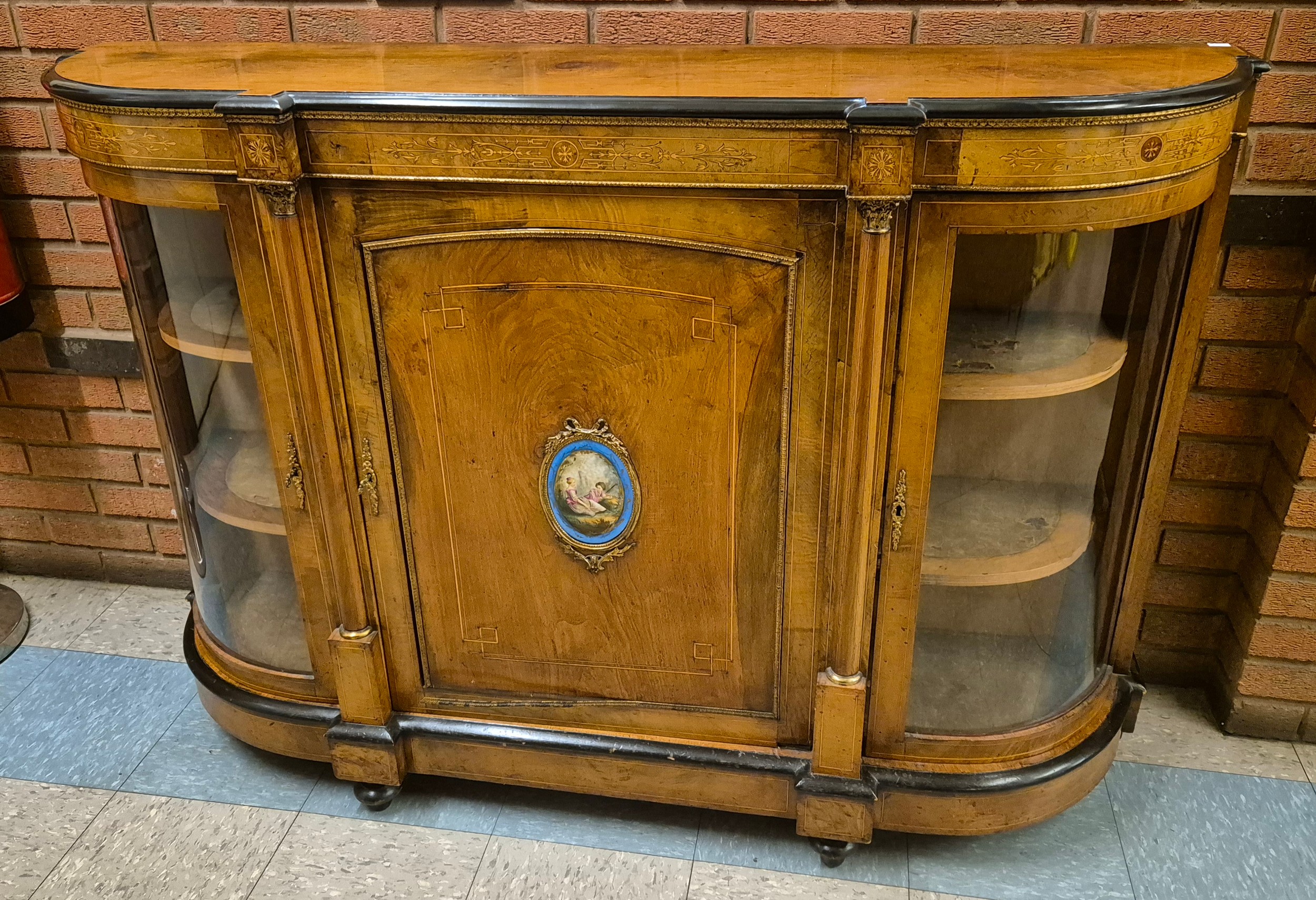 A Victorian inlaid walnut and gilt metal mounted credenza, with Sevres style porcelain oval plaque