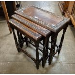 A carved hardwood nest of tables