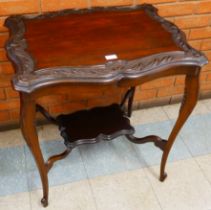 An Edwardian carved mahogany occasional table
