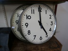 A pair of vintage industrial factory clocks