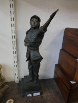 A brass figure of a lady soldier