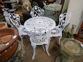 A painted cast alloy garden table and four chairs