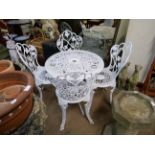 A painted cast alloy garden table and four chairs